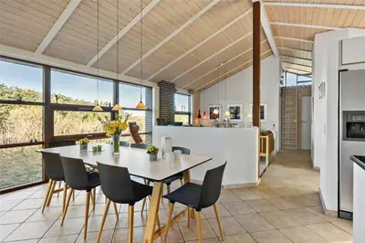 a kitchen and dining room with a table and chairs at BL852-Saltum-Revlingevej-14 in Saltum