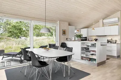 a kitchen and dining room with a table and chairs at BL377-Blokhus-Maxvej-9 in Blokhus