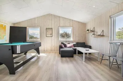 a living room with a pool table and a couch at BL1748-Blokhus-Grossvej-5 in Blokhus