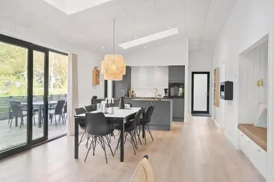 a dining room and kitchen with a table and chairs at BL1485-Blokhus-Jaegervaenget-2-A in Blokhus
