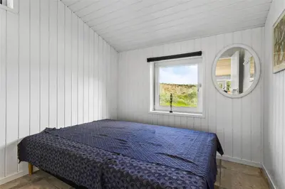 a bedroom with a bed and a window at BL450-Saltum-Graabakken-8 in Saltum