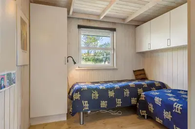 a small room with two beds and a window at BL450-Saltum-Graabakken-8 in Saltum