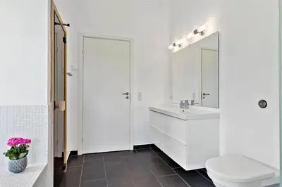 a white bathroom with a toilet and a sink at BL1633-Saltum-Nordvestvej-18 in Saltum