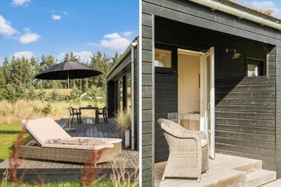 a patio with an umbrella and a table and chairs at BL1445-Saltum-Laustvej-7 in Saltum