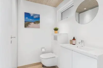 a white bathroom with a toilet and a sink at BL1445-Saltum-Laustvej-7 in Saltum