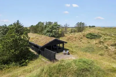 a small building with a grass roof on a field at BL1459-pandrup-Gl-Jacobsvej-24 in Pandrup