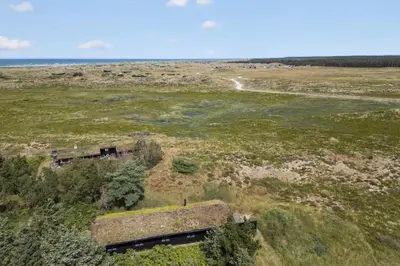 an aerial view of a field with a house at BL1459-pandrup-Gl-Jacobsvej-24 in Pandrup