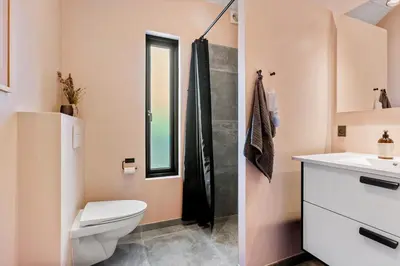 a bathroom with a toilet and a sink and a shower at BL1433-Blokhus-Mollevej-11 in Blokhus