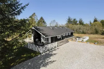 a large house with a deck and a house at BL1588-Pandrup-Lunen-88 in Pandrup