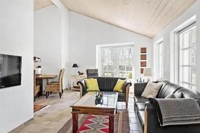 a living room with two couches and a table at BL1588-Pandrup-Lunen-88 in Pandrup