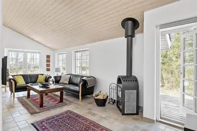 a living room with a wood stove in it at BL1588-Pandrup-Lunen-88 in Pandrup