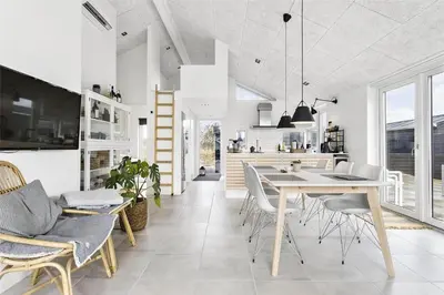 a kitchen and dining room with a table and chairs at BL1667-Blokhus-Klitvejen-24 in Blokhus