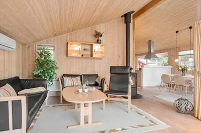 a living room with a couch and chairs and a table at BL1426-Blokhus-Morten-Nielsensvej-86 in Blokhus