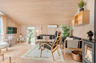 a living room with a table and a couch at BL1426-Blokhus-Morten-Nielsensvej-86 in Blokhus