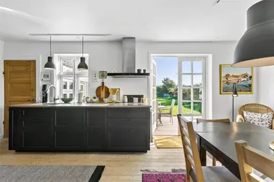 a kitchen with a table and a dining room at BL327-Blokhus-Sonder-I-By-23 in Blokhus