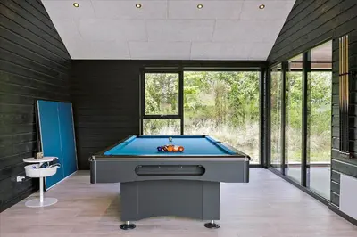 a pool table in the middle of a room at BL1513-Blokhus-Gyldenrisvej-18 in Blokhus