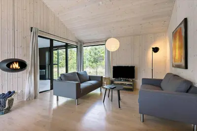 a living room with two couches and a television at BL1513-Blokhus-Gyldenrisvej-18 in Blokhus