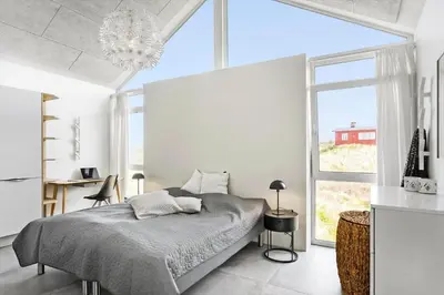 a bedroom with a bed and a large window at BL1468-Blokhus-Moreavej-59-B in Blokhus