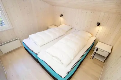 a small room with a bed in a wall at BL289-Blokhus-Moreavej-41 in Blokhus