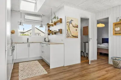 a kitchen with white cabinets and a sink at BL1209-Blokhus-Bellevueparken-14 in Blokhus