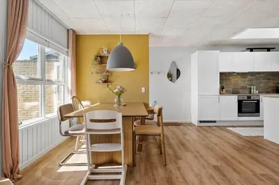 a kitchen and dining room with a table and chairs at BL1209-Blokhus-Bellevueparken-14 in Blokhus