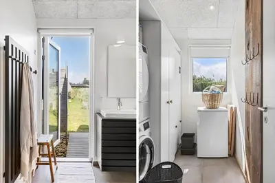 a bathroom with a sink and a washing machine at BL1712-Blokhus-Vestvej-6 in Blokhus
