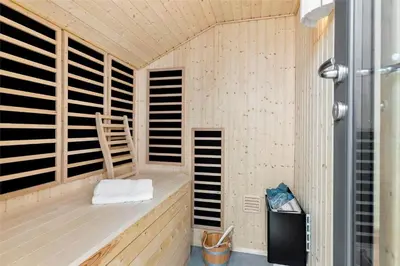 a sauna with wooden shutters in a room at BL1712-Blokhus-Vestvej-6 in Blokhus