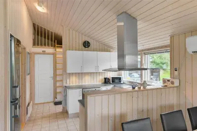 a kitchen with white cabinets and a stove top oven at BL757-Saltum-Tolhoj-12 in Saltum