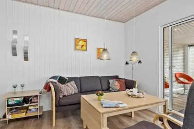 a living room with a couch and a table at BL1359-Blokhus-Bellevueparken-24 in Blokhus