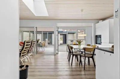a kitchen and dining room with a table and chairs at BL1359-Blokhus-Bellevueparken-24 in Blokhus