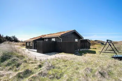 a house in a field next to a grassy field at BL1497-Pandrup-Hunetorp-Klitvej-271 in Pandrup