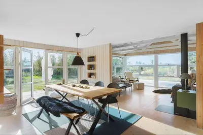 a living room with a wooden table and chairs at BL1589-Saltum-Bondagervej-52 in Saltum