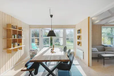 a dining room with a wooden table and chairs at BL1589-Saltum-Bondagervej-52 in Saltum