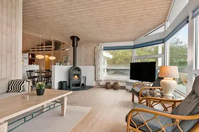 a living room with a couch and a fireplace at BL295-Saltum-Graabakken-2 in Saltum