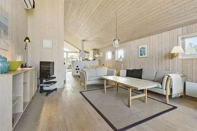 a living room with a couch and a table at BL401-Blokhus-Lyngvej-12 in Blokhus