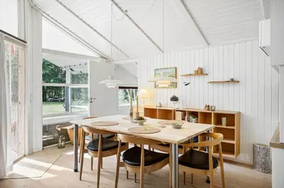 a dining room with a table and chairs at BL1338-Pandrup-Lunekrogen-10 in Pandrup