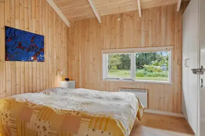 a bedroom with a bed and a window at BL279-Pandrup-Rodhusparken-71 in Pandrup