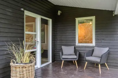 two chairs sitting on the porch of a house at BL1774-Blokhus-Ronliensvej-11 in Blokhus