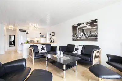a living room with black furniture and a table at BL475-Blokhus-Peder-Madsensvej-21 in Blokhus