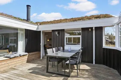 a patio with a table and chairs on a deck at BL1461-Saltum-Kvansletten-29 in Saltum