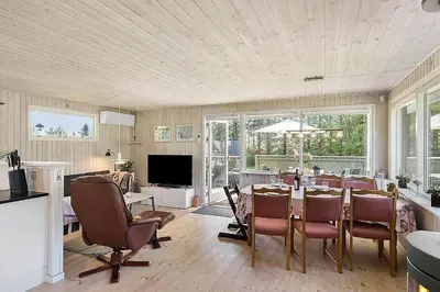 a dining room with a table and chairs at BL1366-Blokhus-Berberisvej-56 in Blokhus