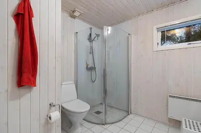 a bathroom with a shower and a toilet at BL1451-Blokhus-Quintusvej-5 in Blokhus