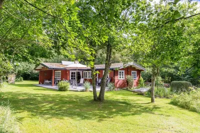 a red house in the middle of a yard at BL1694-Saltum-Klaus-Bjergsvej-8 in Saltum