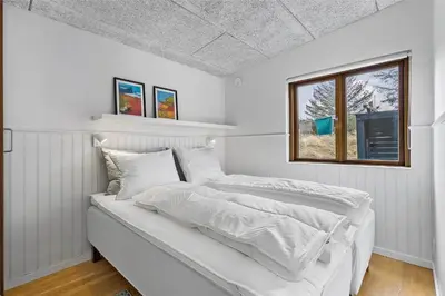two beds in a white room with a window at BL980-Saltum-Faarup-Klitvej-46 in Saltum