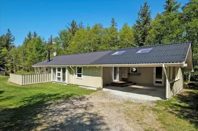 a small house with a gray roof at BL565-Pandrup-Lunekrogen-22 in Pandrup