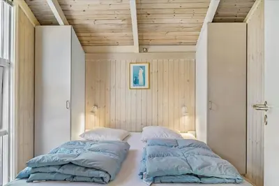 a bed with two pillows on it in a room at BL565-Pandrup-Lunekrogen-22 in Pandrup