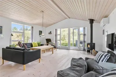 a living room with a couch and a fireplace at BL747-Saltum-Graabakken-7 in Saltum