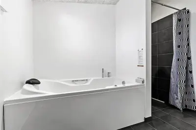 a white bathroom with a sink and a shower at BL1110-Blokhus-Bloksbjerg-7 in Blokhus