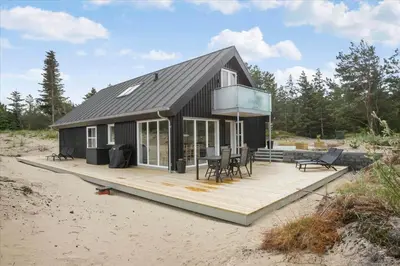 a house on a wooden deck on the beach at BL1506-Saltum-Kronhjortvej-15 in Saltum