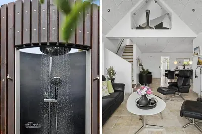 a living room with a staircase and a living room with a table at BL1509-Blokhus-Stromsvej-7 in Blokhus